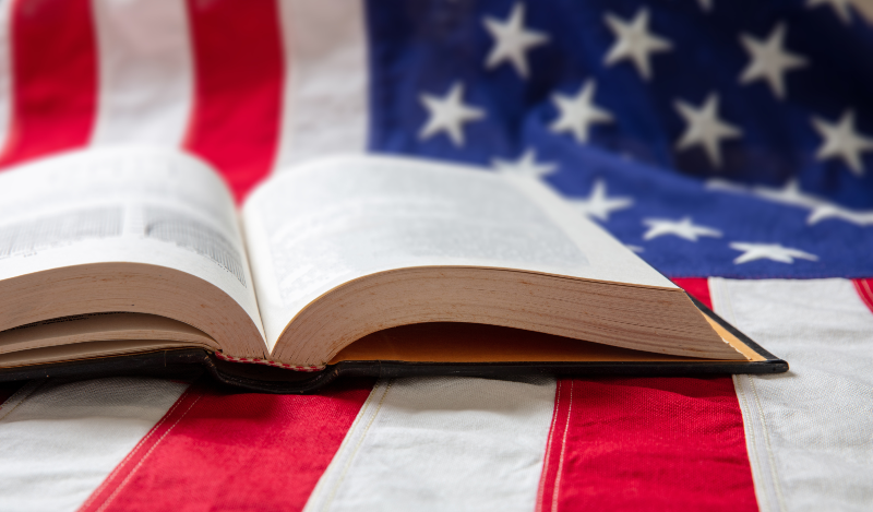 open book sitting on an American flag