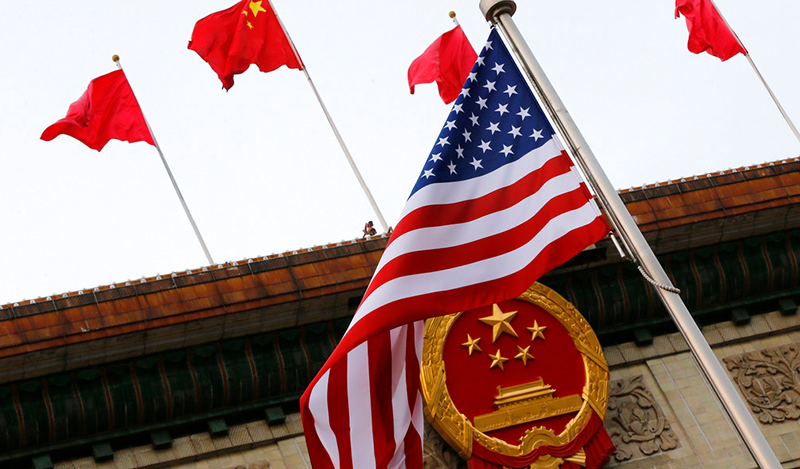 An American flag is flown next to the Chinese national emblem and flags during a welcome ceremony for visiting U.S. President Donald Trump outside the Great Hall of the People in Beijing, Thursday, Nov. 9, 2017. President Donald Trump sought to present a united front with Chinese President Xi Jinping following two days of meetings Thursday, despite lingering differences over trade and North Korea. (AP Photo/Andy Wong)